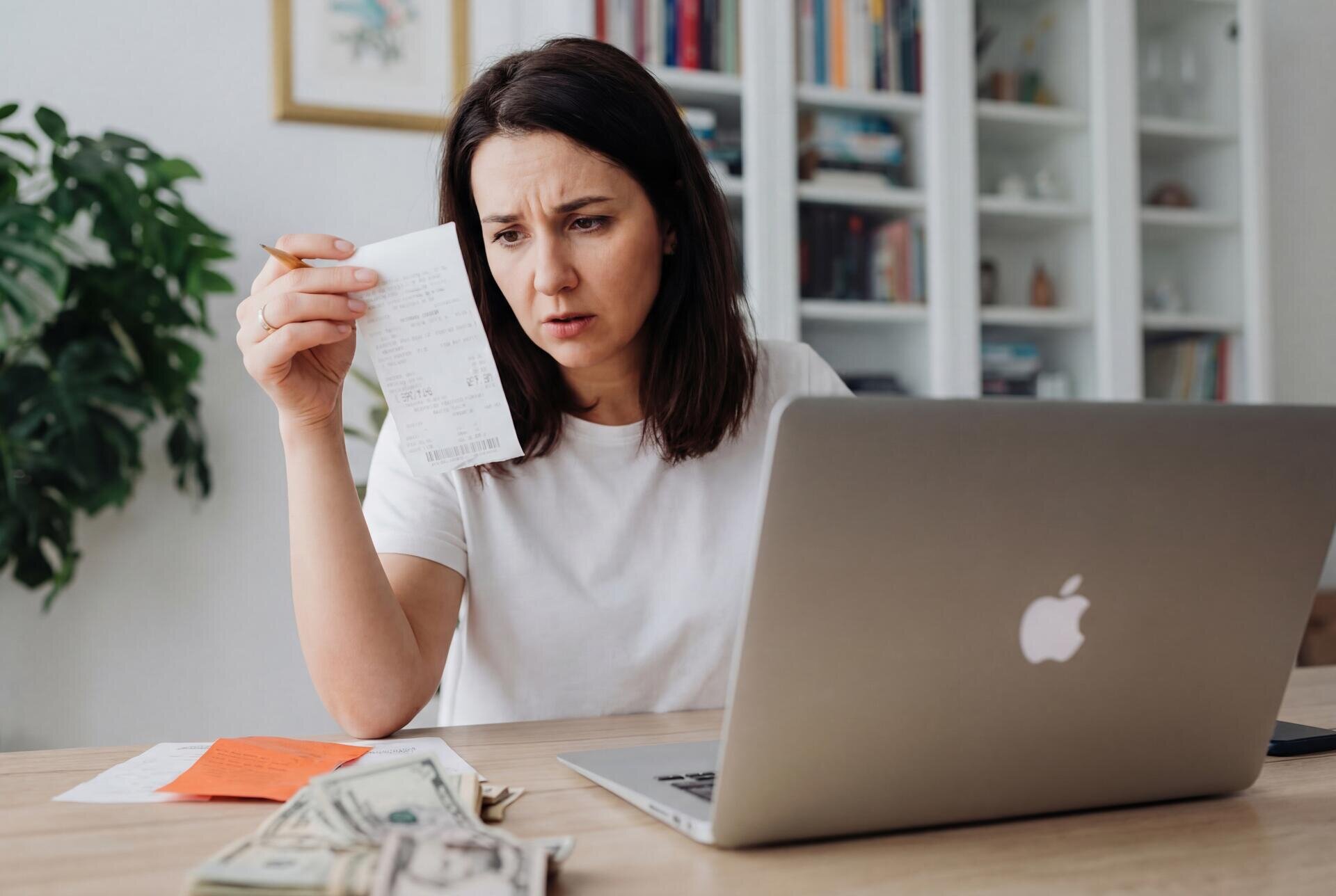 Happy family celebrating lower electricity bills with solar panels on their home